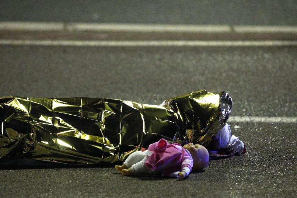 A body is seen on the ground after at least 30 people were killed in the southern French town of Nice when a truck ran into a crowd celebrating the Bastille Day national holiday